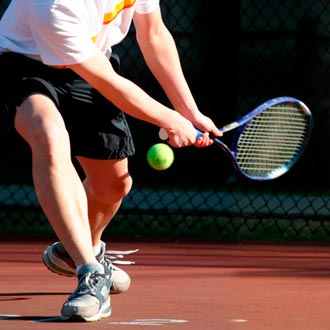 foto de tenista con raqueta preparado para golpear la pelota de tenis